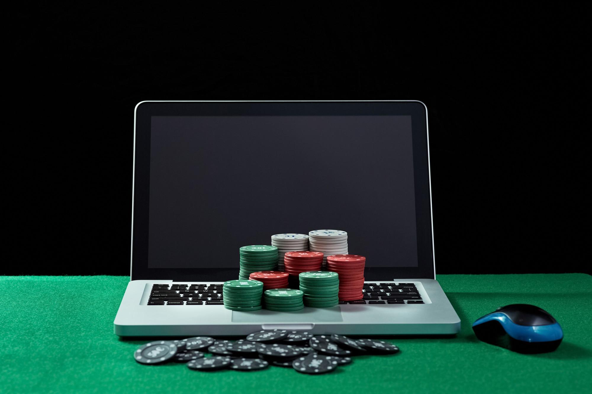 image-casino-chips-keyboard-notebook-green-table-concept-online-gambling-poker-virtual-casino